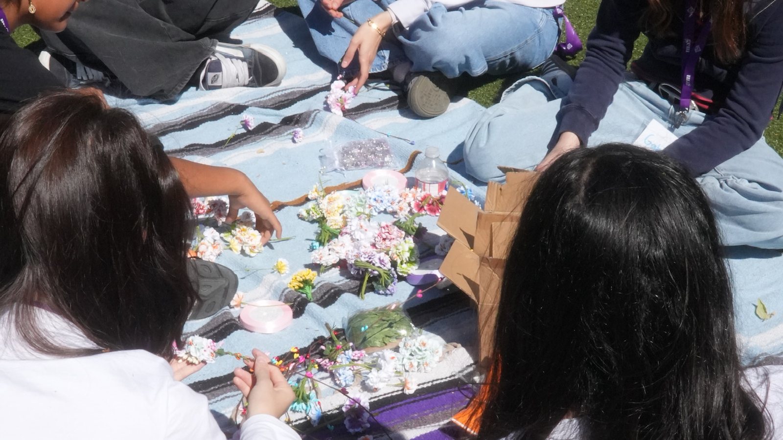 Teen creators working together outdoors at GEMfest 2024